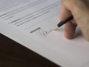 Signing a Dermaplaning Consent Form